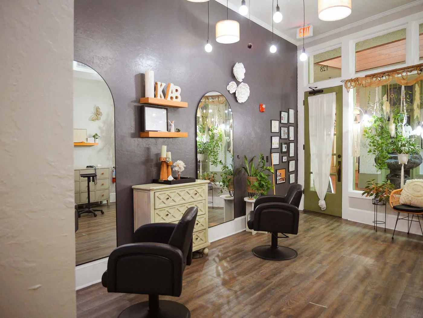 The styling floor with black chairs, mirrors and wood shelves